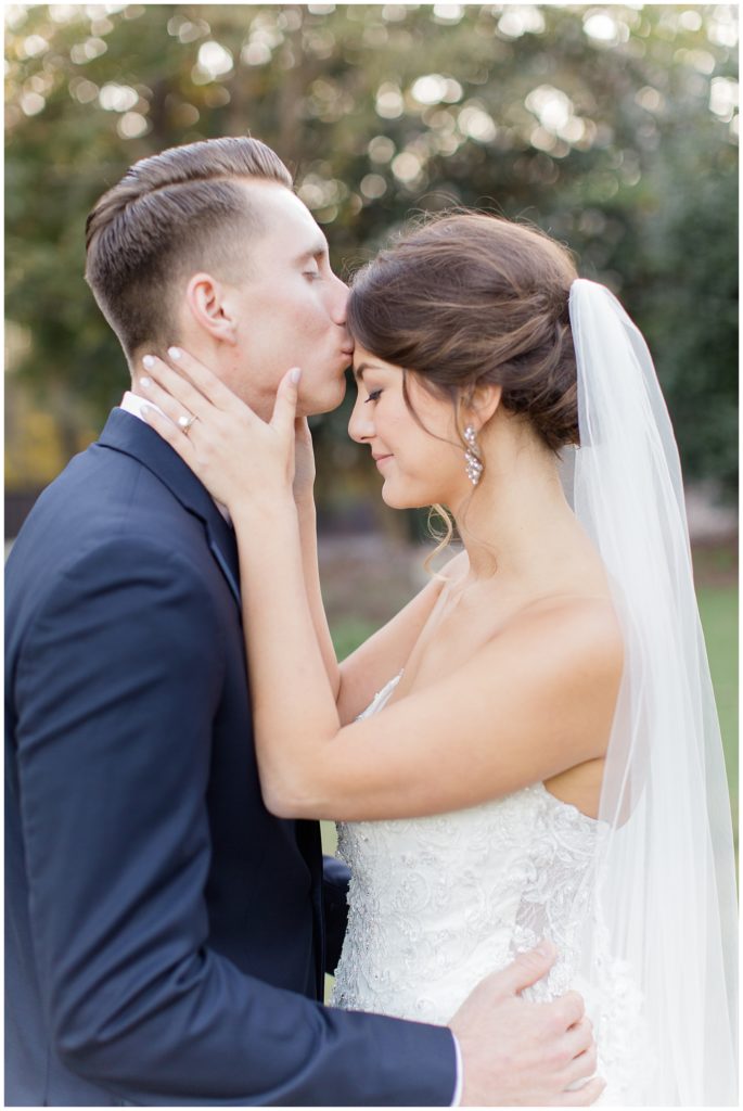 groom kissing bride forehead