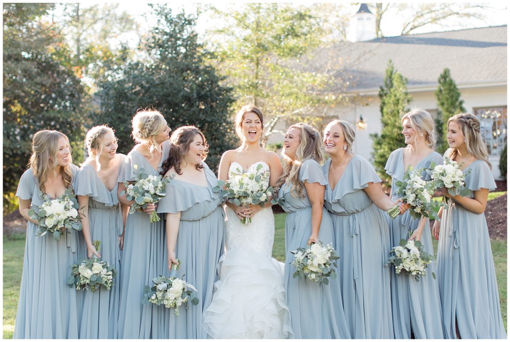 bridesmaids in blue dresses laughing 