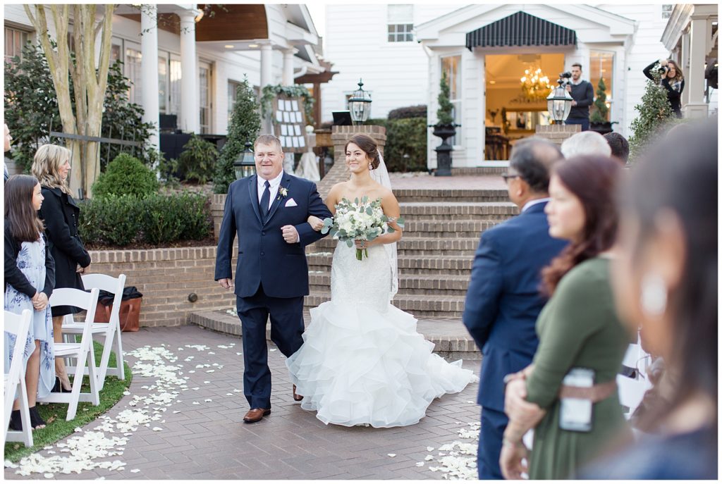 bride walking down the aisle with her father 