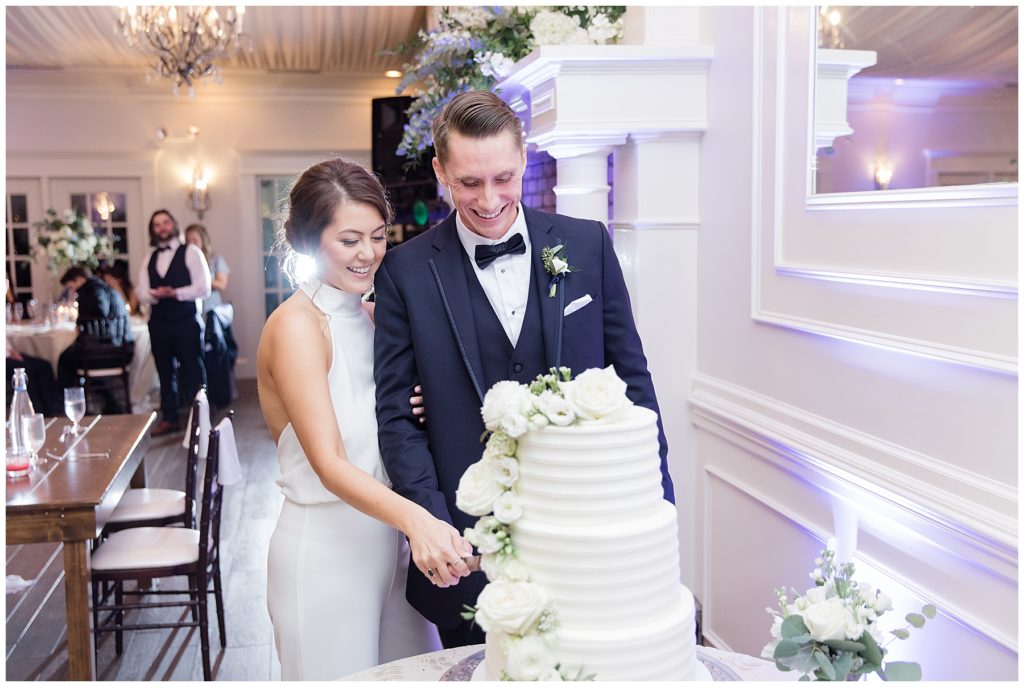 bride and groom cutting cake 