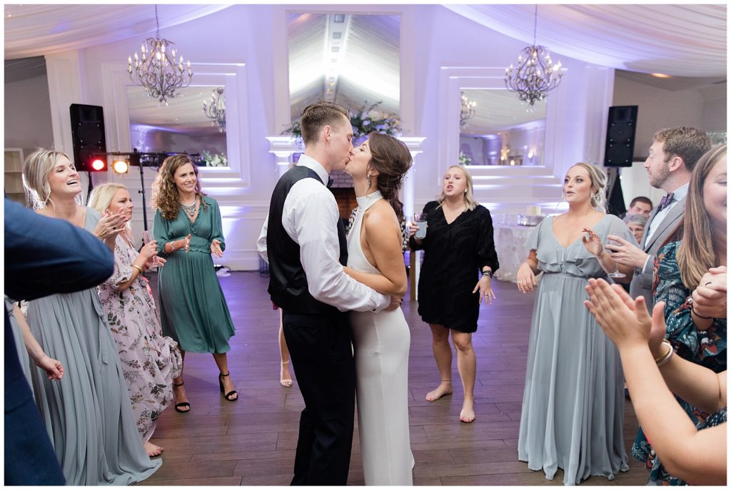 bride and groom kissing on dance floor 